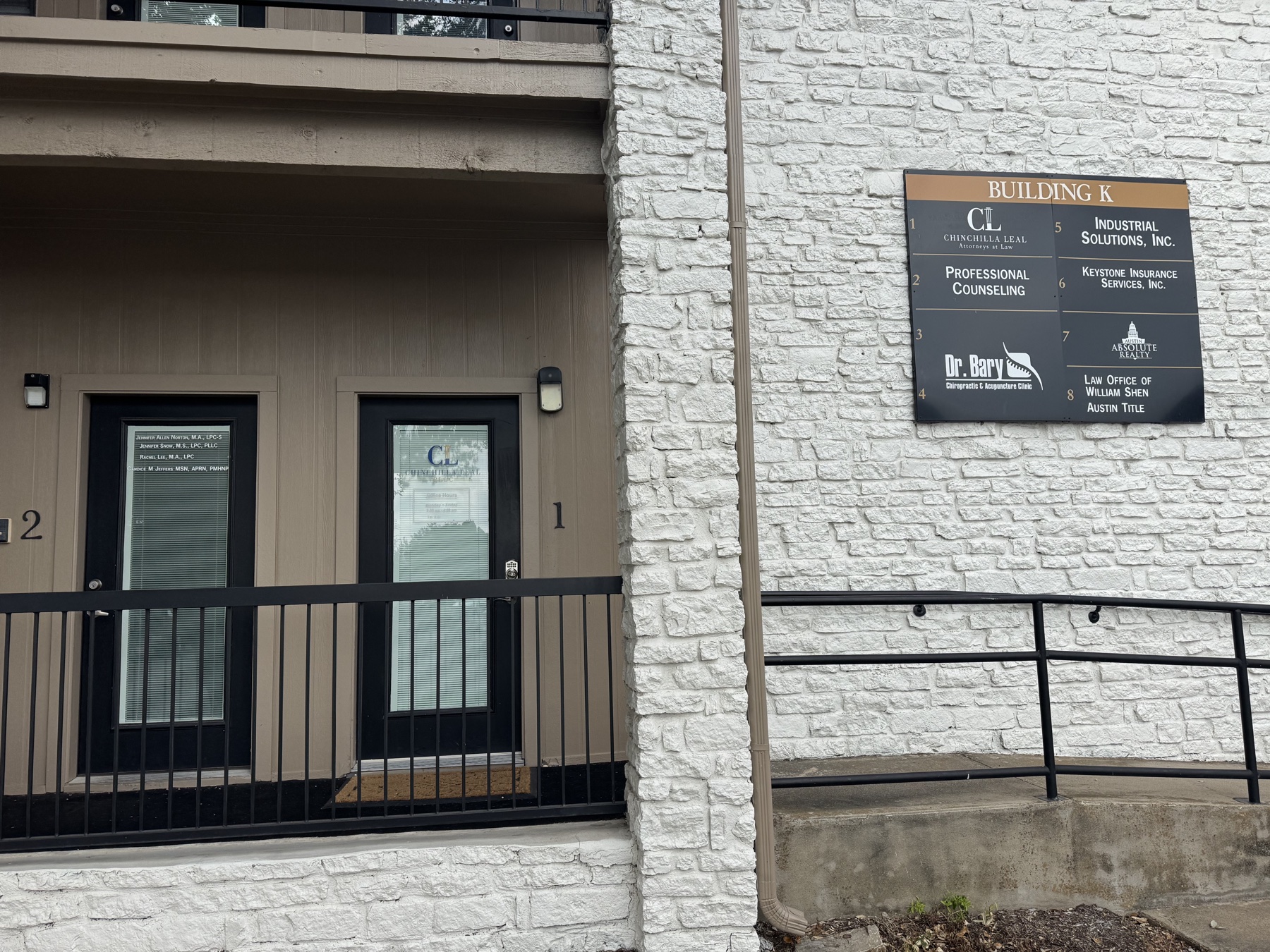 Exterior entrance and directory sign for Chinchilla Leal Attorneys at Law in Austin, Texas