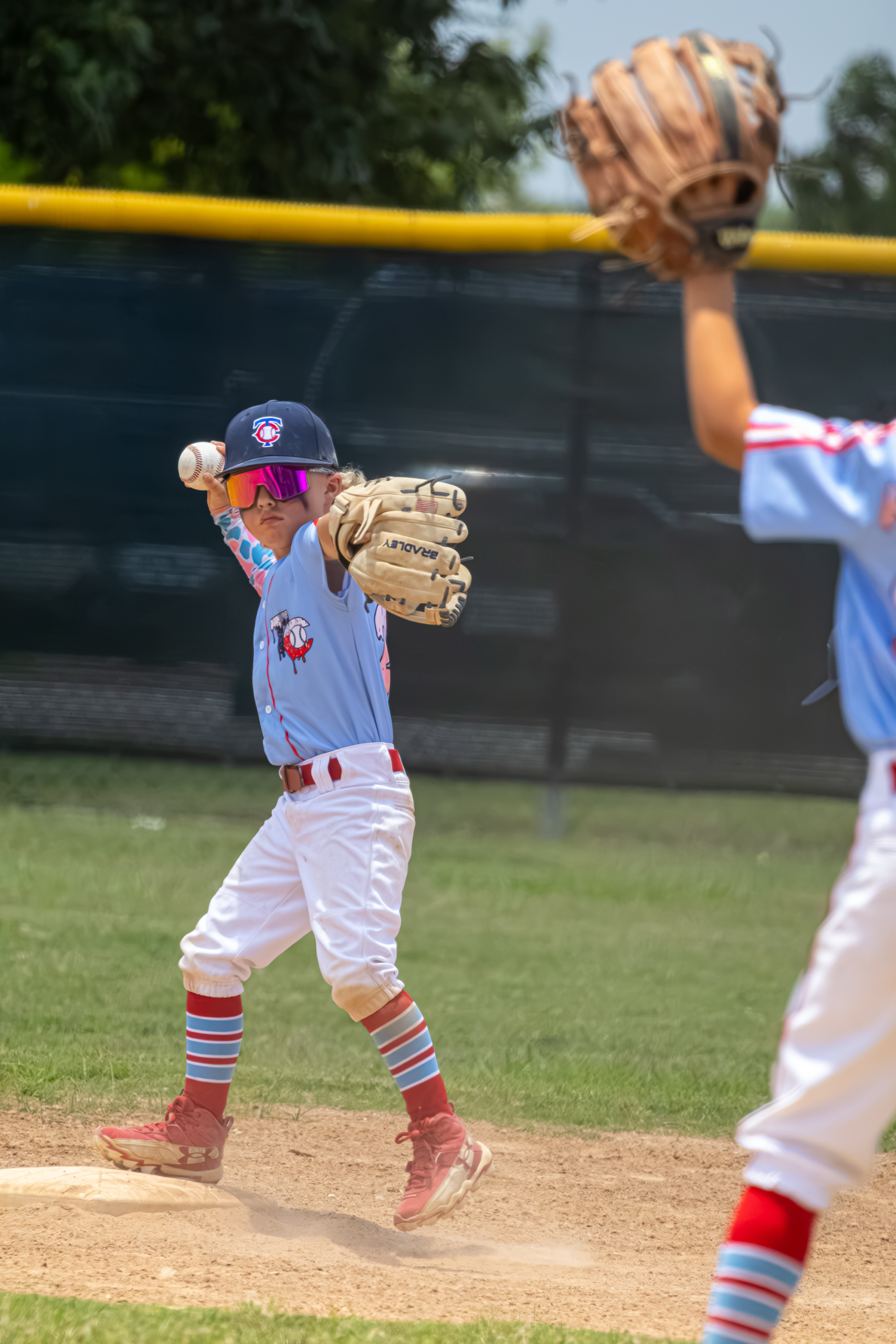 Mudbugs youth baseball pitcher in action