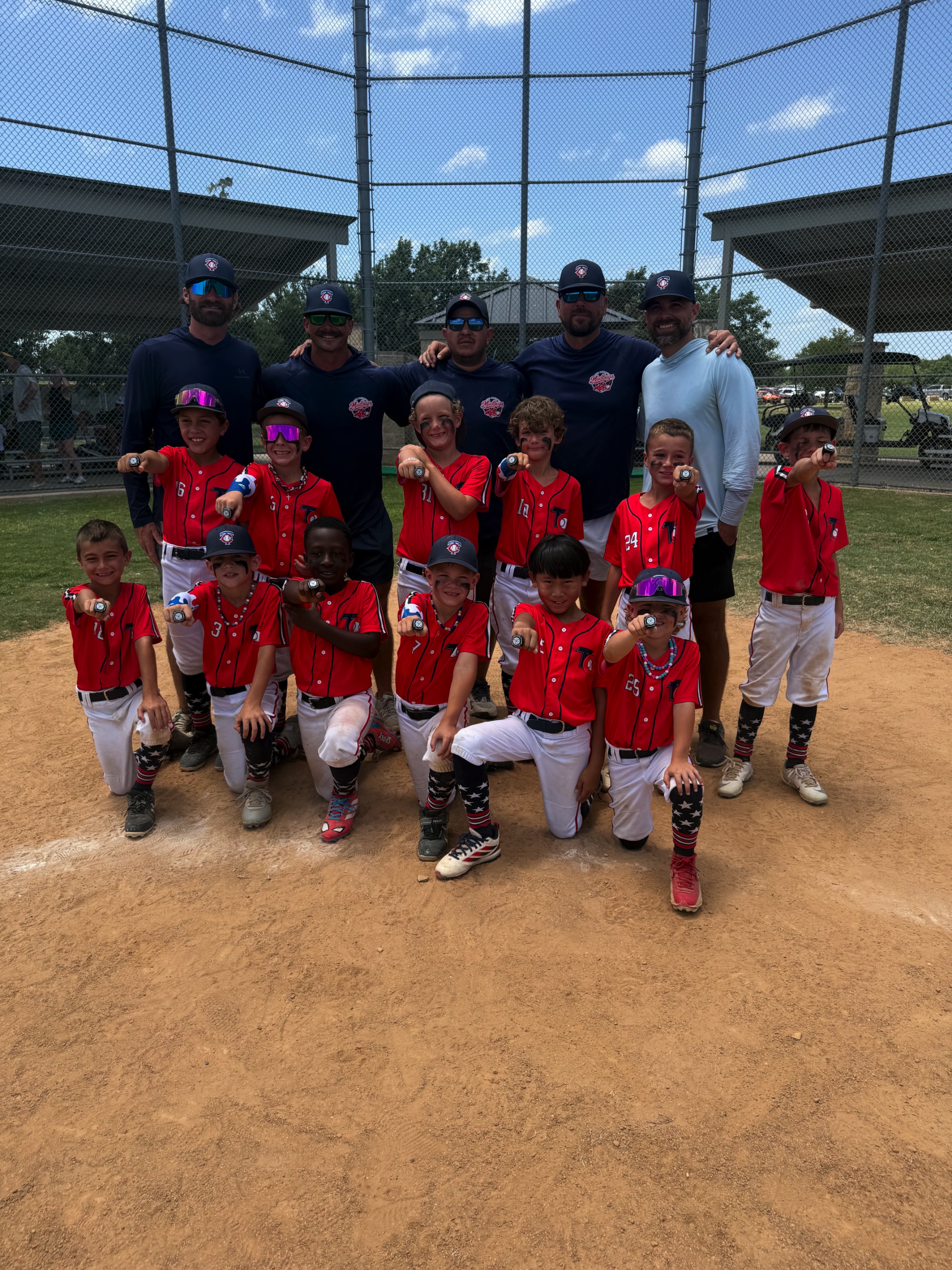 Town and Country 8U Mudbugs players and coaches celebrating their third-place finish
